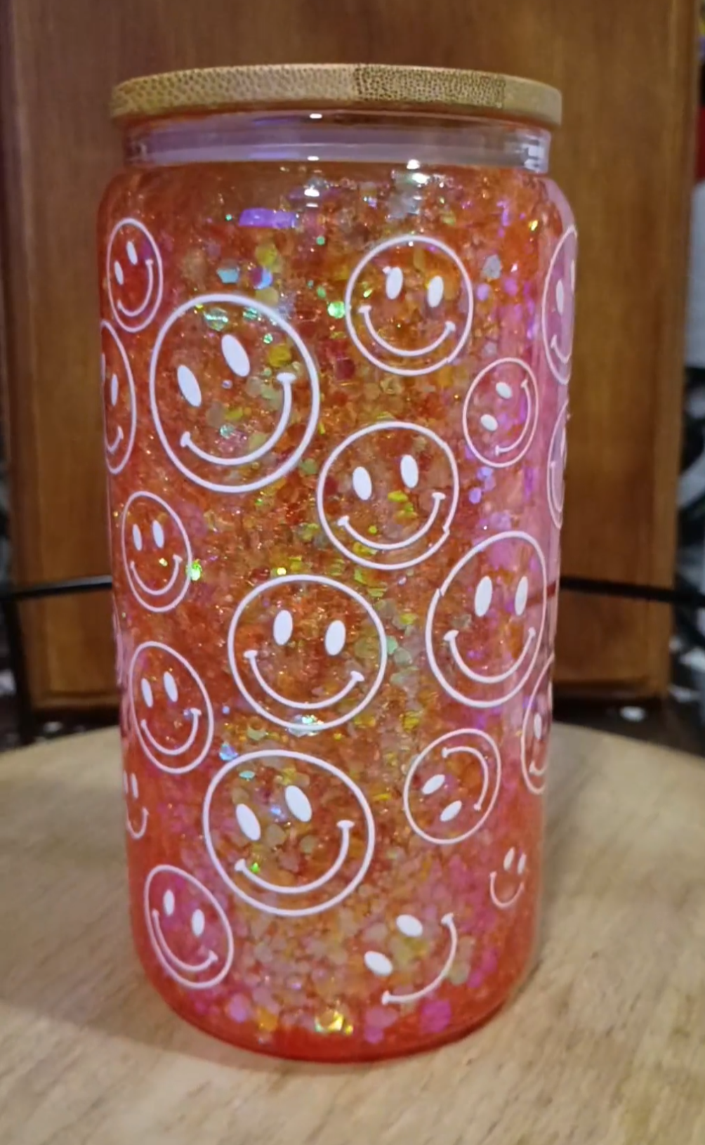 Custom Smiley Face Glitter Snow Globe Tumbler with orange glitter and bamboo lid