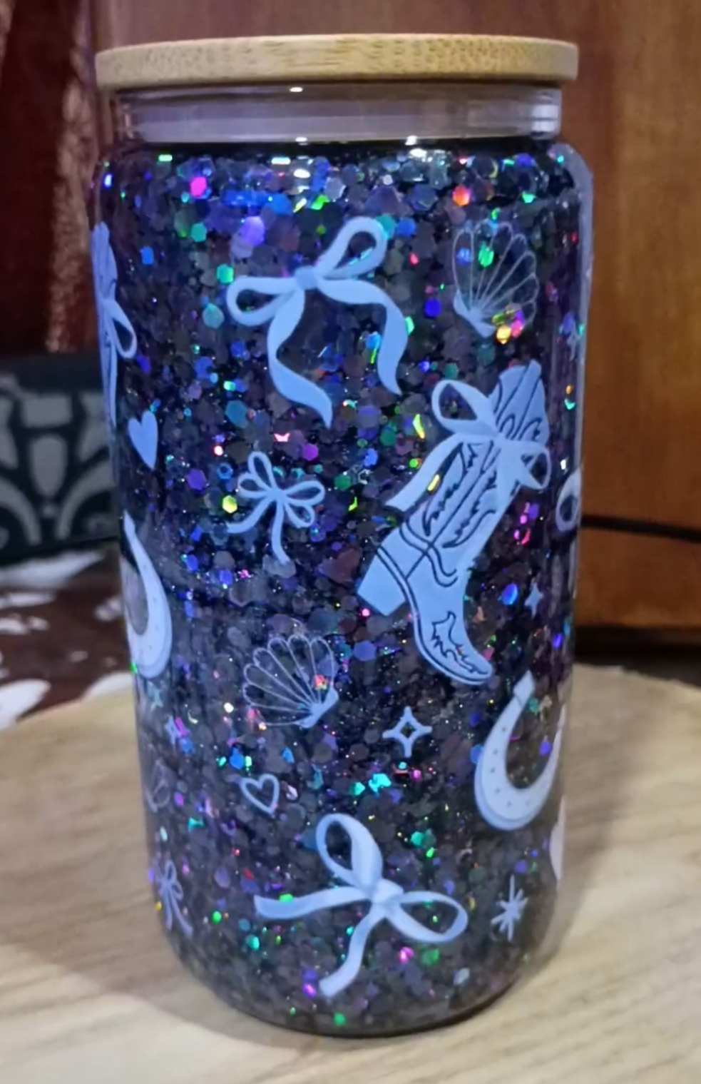 Custom Western Cowgirl Glitter Snow Globe Tumbler with navy holographic glitter, cowboy boots, bows, and bamboo lid
